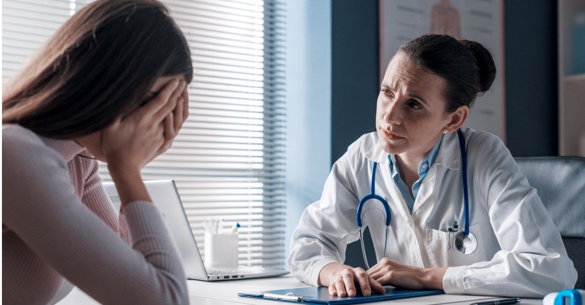 doctor-assisting-a-crying-patient-in-the-office